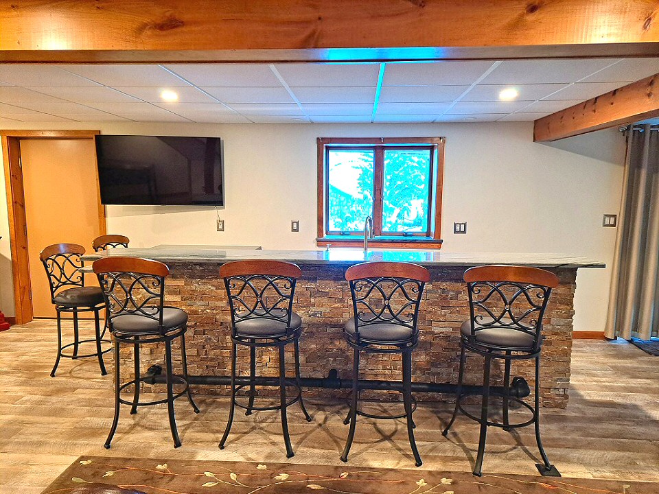 Basement Remodeling Removed existing cabinets along the wall of the basement. Framed up knee walls around bar area.