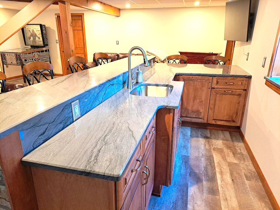 The interior of the bar got custom cabinets from Blue Mountain Woodworking and countertops from Eastern Surfaces for the bar area as well as windowsill.